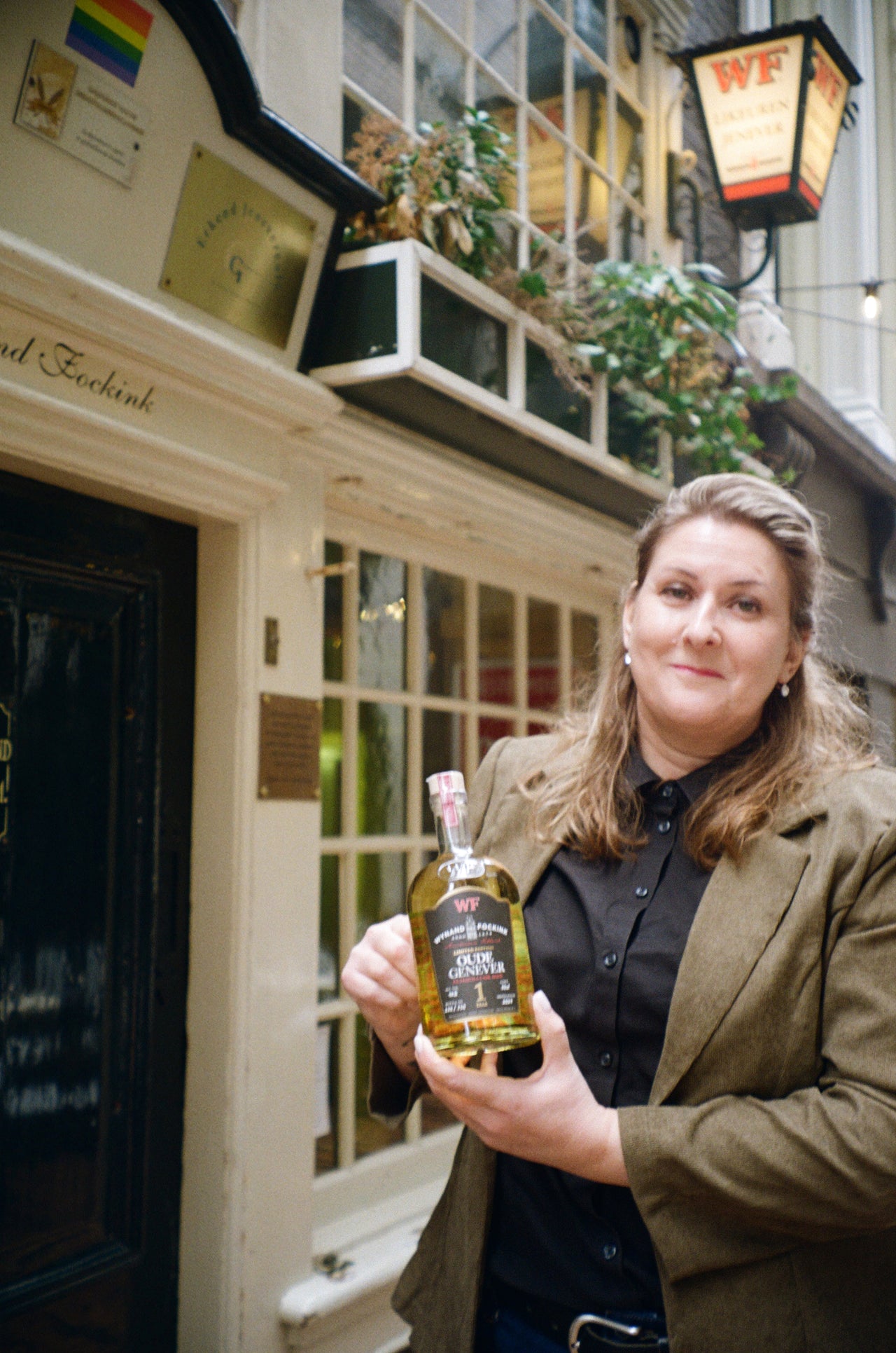 Master distiller holding bottle wynand fockink genever
